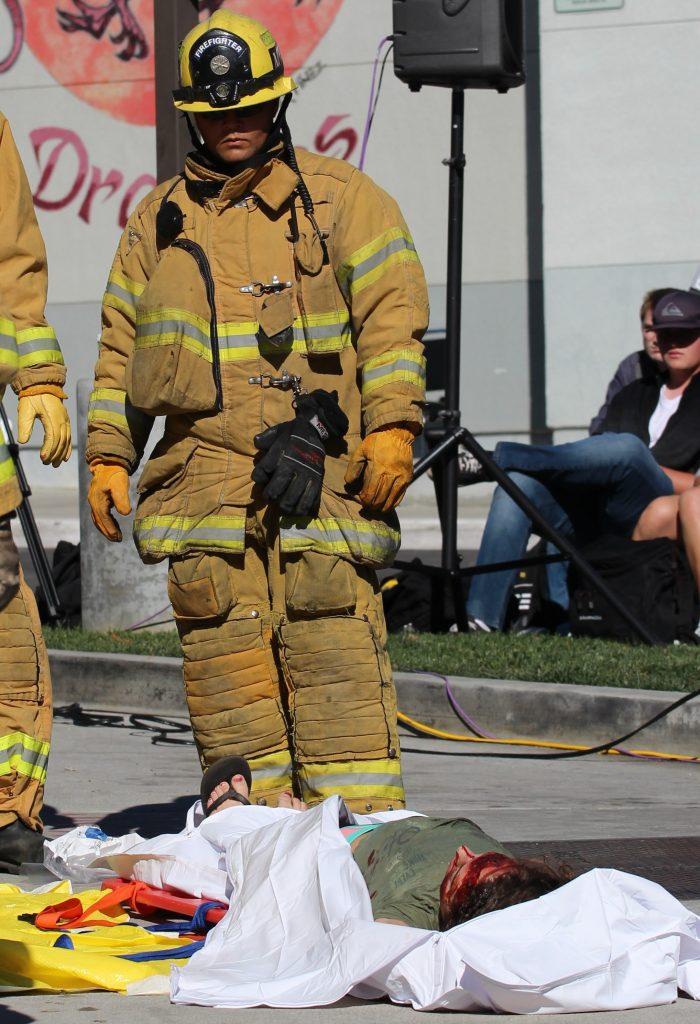 A firefighter surveys the body of senior Lauren Dalmatoff before she is placed in a body bag. Credit: Carrie Coonan/The Foothill Dragon Press
