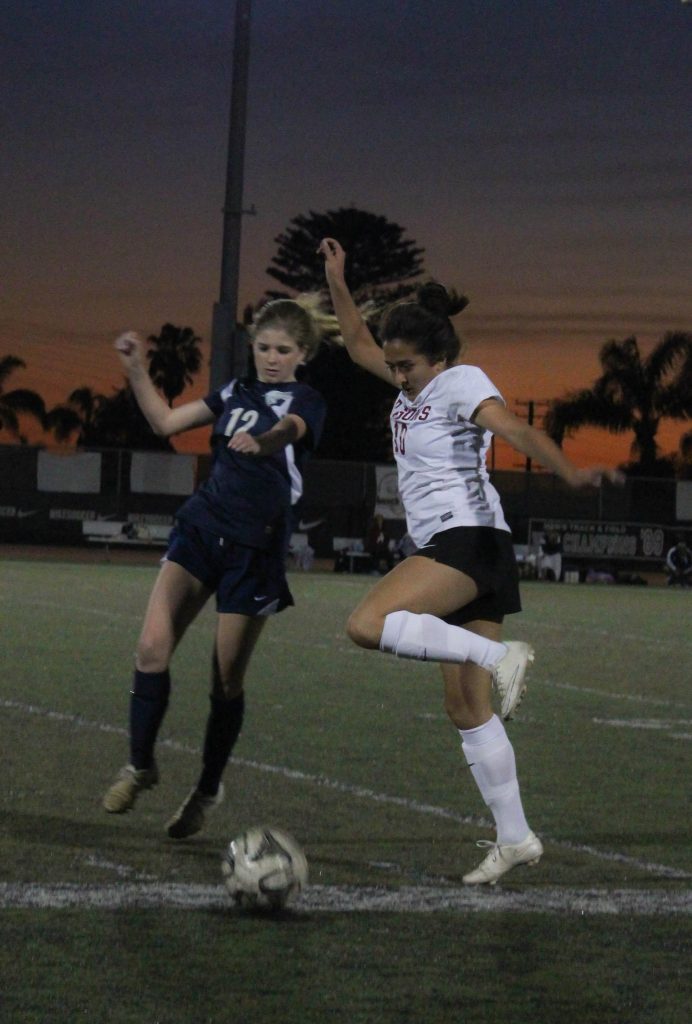 Junior Gabby Pido competes with a Villanova player for possession of the ball during Thursday night's home game. Credit: Jessie Snyder/The Foothill Dragon Press