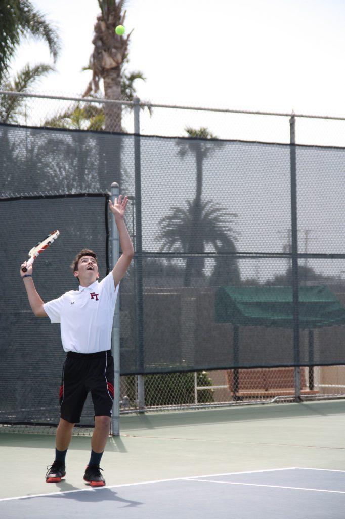 Freshman Kaylan Ouerbacker serves during his double match with Austin Gama. Photo Credit: Gabrialla Cockerell / The Foothill Dragon Press 