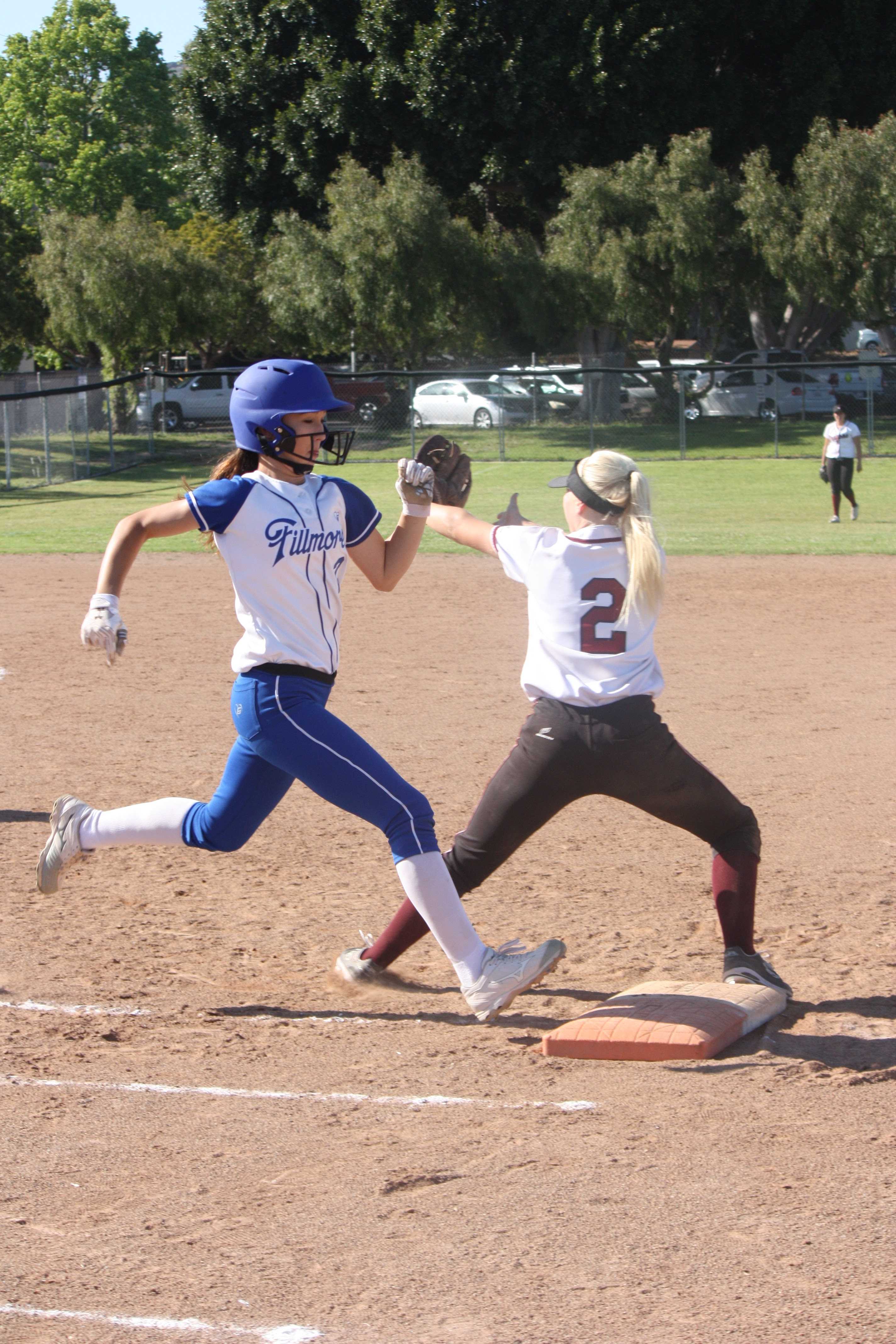 Sophomore Jamie Dietz (2) catches the ball at first base, tagging out Fillmore varsity batter. Credit: Gabrialla Cockerell/ The Foothill Dragon Press