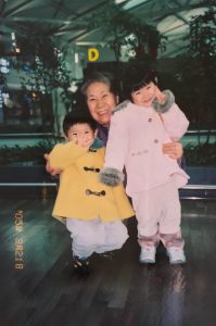 Sowon Lee (left) with her younger brother and grandmother at airport in South Korea before leaving for California for the first time. Credit: Sowon Lee (Used with permission)