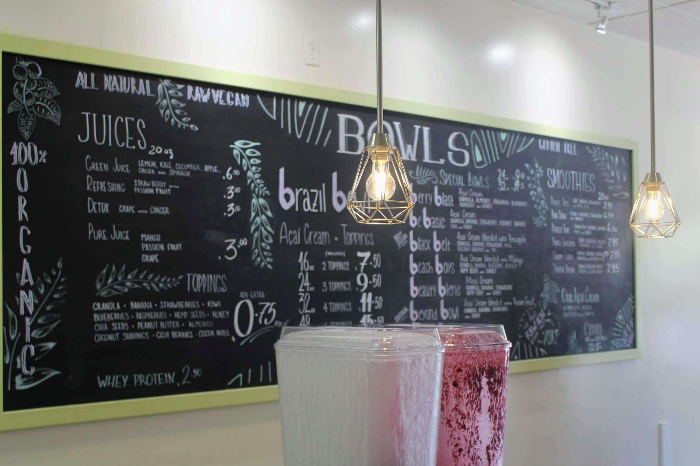 The chalkboard menu was designed by an artist from San Diego and boasts options beyond just açaí bowls, like smoothies and juices. Credit: Abby Sourwine / The Foothill Dragon Press