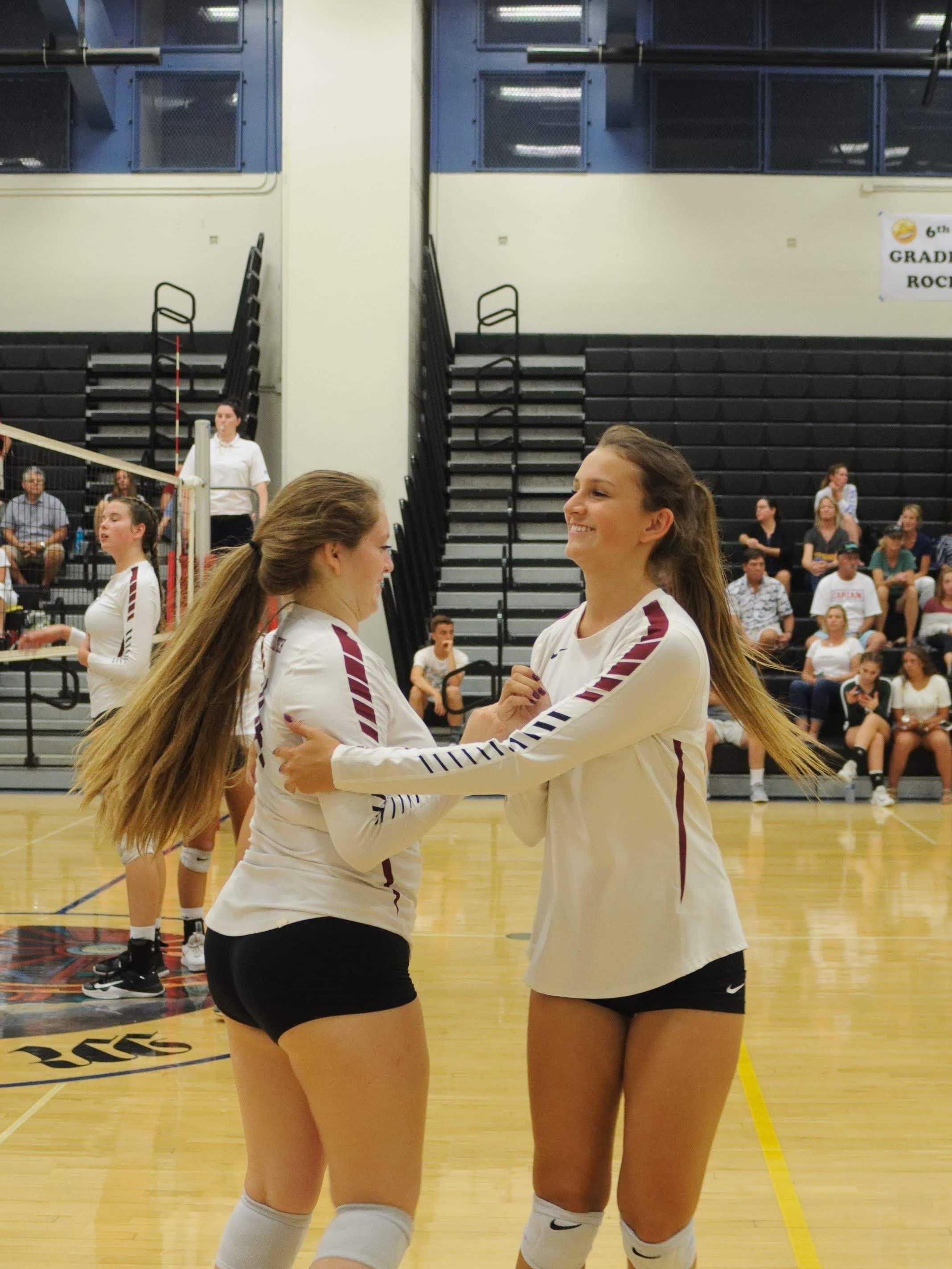 Pearl Esparza ‘19 congratulating sister Angel Esparza ‘20 as she subs in. Credit: Muriel Rowley / The Foothill Dragon Press
