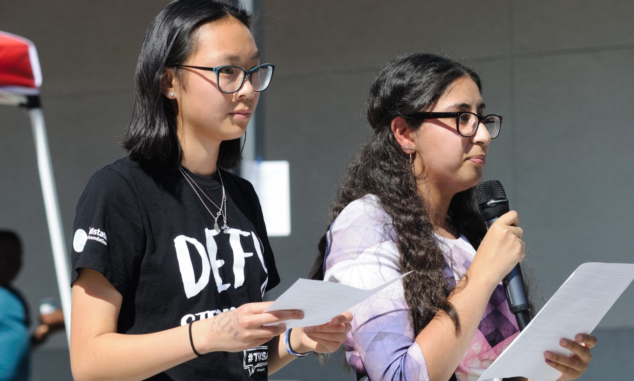 Leaders of WE Club Shealyn Massey ‘19 and Yoanna Soliman ‘19 stand on the stage and ask various questions to students that bring awareness to inequality. Credit: Muriel Rowley / The Foothill Dragon Press