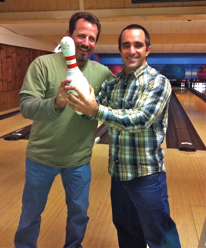 Math teacher Rick Villano, left, gives the bowling trophy to math and PE teacher Bill Huffman. Credit: Julie Villano.
