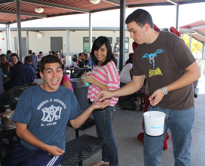 ASB member senior David White hands out candy to junior Daniel Garcia to help motivate students to do well on their testing this year. Credit: Eva Morales/The Foothill Dragon Press.