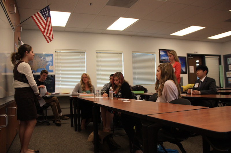 Freshman Patricia McCoy (left) answers a question from Daisy Myring (far right) about why food companies hide the ingredients in their products at Monday's Ninth Grade Project presentation. Credit: Felicia Perez/The Foothill Dragon Press