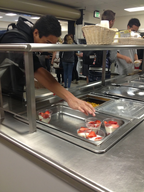 Senior Anthony Balolong-Reyes reaches for a yogurt cup in the cafeteria. Credit: Felicia Perez/The Foothill Dragon Press