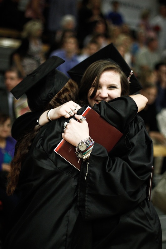 Senior Hannah Strohman hugs a fellow graduate at Foothill's 2012 Commencement ceremony. Credit: Bethany Fankhauser/The Foothill Dragon Press
