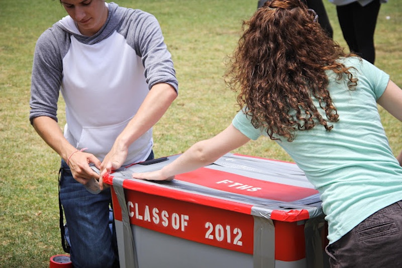 Seniors Trevor Kirby and Shaena Singer tape Foothill's first time capsule at the senior picnic. Credit: Bethany Fankhauser/The Foothill Dragon Press.