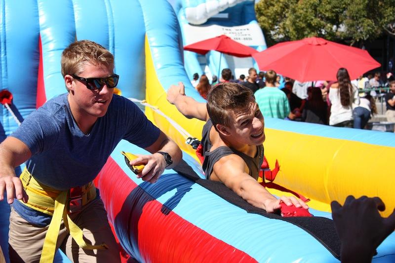 Juniors Andrew Miech and compete on the bungee inflatable at the fall Renaissance rally themed Kindergarten. Credit: Johnathan Carriger/The Foothill Dragon Press