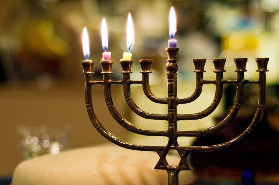 A menorah is lit as part of the Hanukkah celebration. Flickr Creative Commons Credit: David Goehring