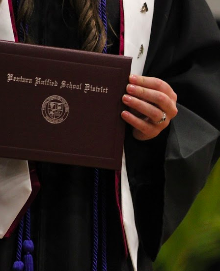 A senior displays their diploma. Credit: Rachel Horiuchi/The Foothill Dragon Press