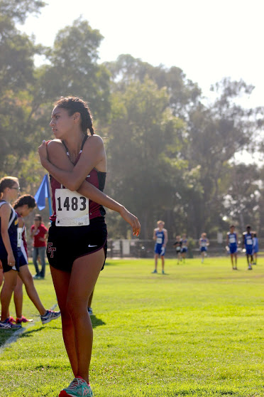 Senior Nyssa Torres stretches after her race. Credit: Rachel Horiuchi/The Foothill Dragon Press