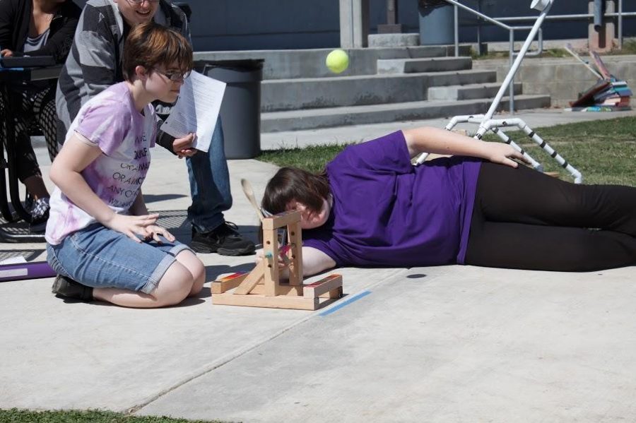 Sophomore Natalie Eberle catapults the tennis ball as part of the conceptual physics class project. Credit: Grayson McCoy/The Foothill Dragon Press  