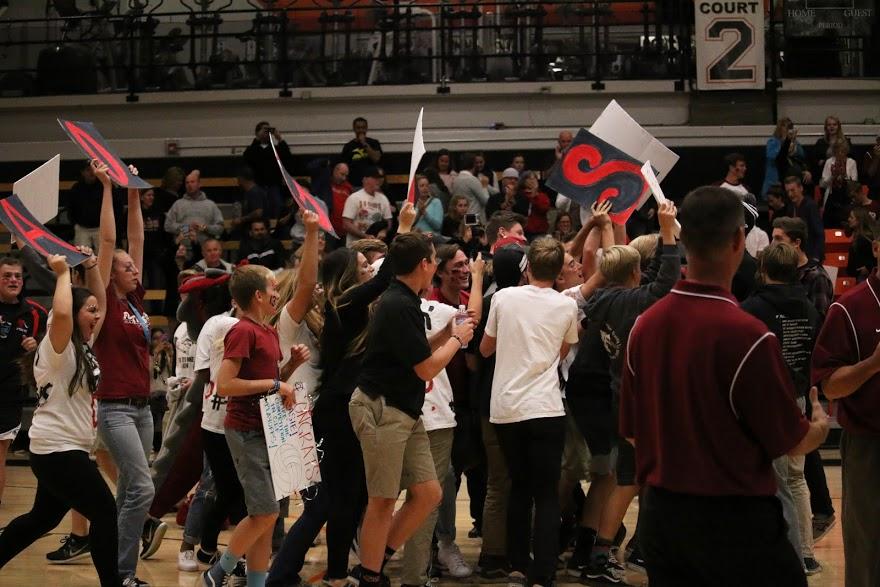 Foothill fans run onto the court after the girls' varsity volleyball team wins their first playoff game on Tuesday night. Credit: Grace Carey/The Foothill Dragon Press