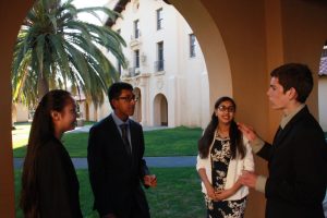 Four Foothill junior varsity debaters compare rounds. Credit: Anna Lapteva / The Foothill Dragon Press.