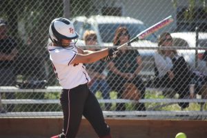 Junior Taylor Wreesman (12), with a stroke of her bat, gets ready to sprint to first base. 
Credit: Gabrialla Cockerell/ The Foothill Dragon Press