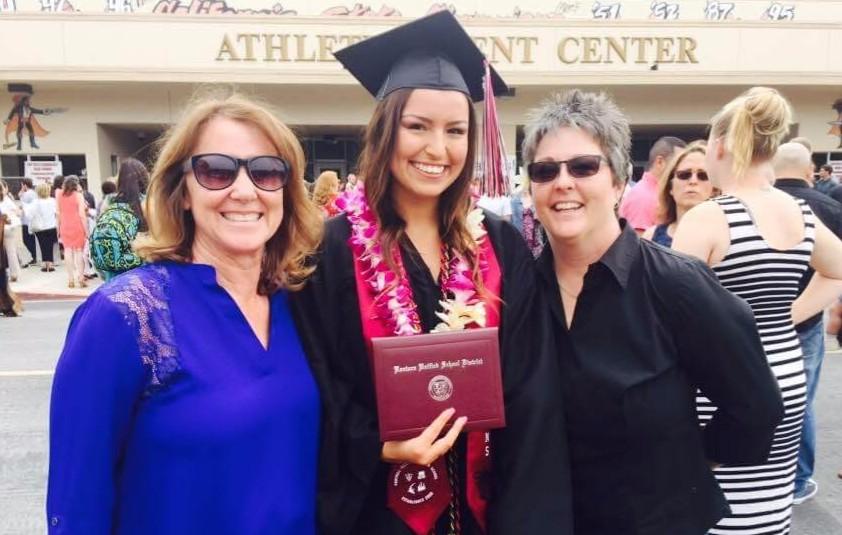 Gatlin with her parents. Reprinted with permission from Adriana Doyle.