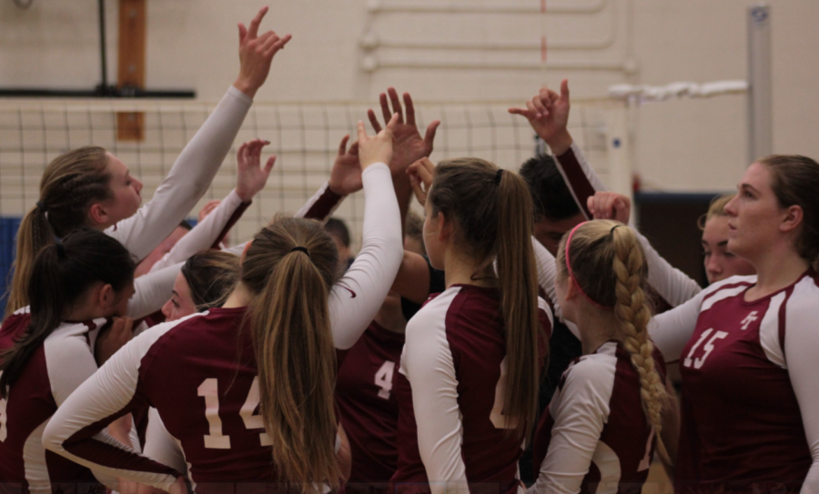 FTHS' team cheers before getting ready to go back out on the court. Credit: Jason Messner / The Foothill Dragon Press