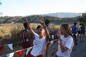 Hana Vrablik and Blythe Blakeman '19 cheer on their teammates after they've finished. Credit: Abby Sourwine / The Foothill Dragon Press