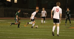 Max Turville 21 dribbles across the field looking for an open pass. Credit: Jason Messner / The Foothill Dragon Press