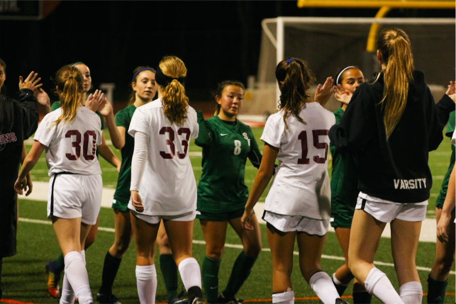 The Dragons and Seraphs exchange high-fives after a 5-0 win for the Dragons. Credit: Jason Messner / The Foothill Dragon Press