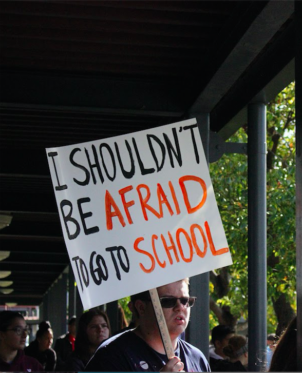 Nathan Gherardhi '18 holds a sign in support of the goals of the walk out. Credit: Gabrialla Cockerell / The Foothill Dragon Press 