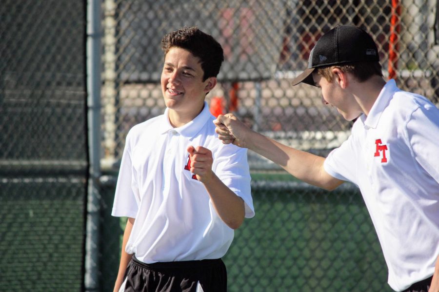 Devin Franke 21 and Tomas Carrillo 21 fist bump after scoring during their doubles. 
Credit: Gabrialla Cockerell / The Foothill Dragon Press