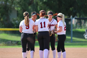 Infield players huddle up after Jamie Dietz 19 makes the second out of the last inning. Credit: Olivia Sanford / The Foothill Dragon Press