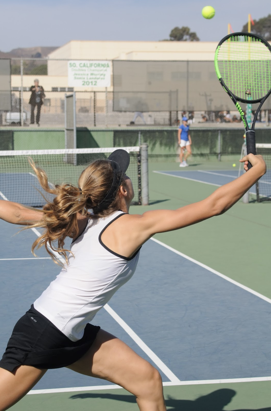 Noelle Hayward '21 reaches for the ball and manages to save it by hitting it over the net. Credit: Muriel Rowley / The Foothill Dragon Press