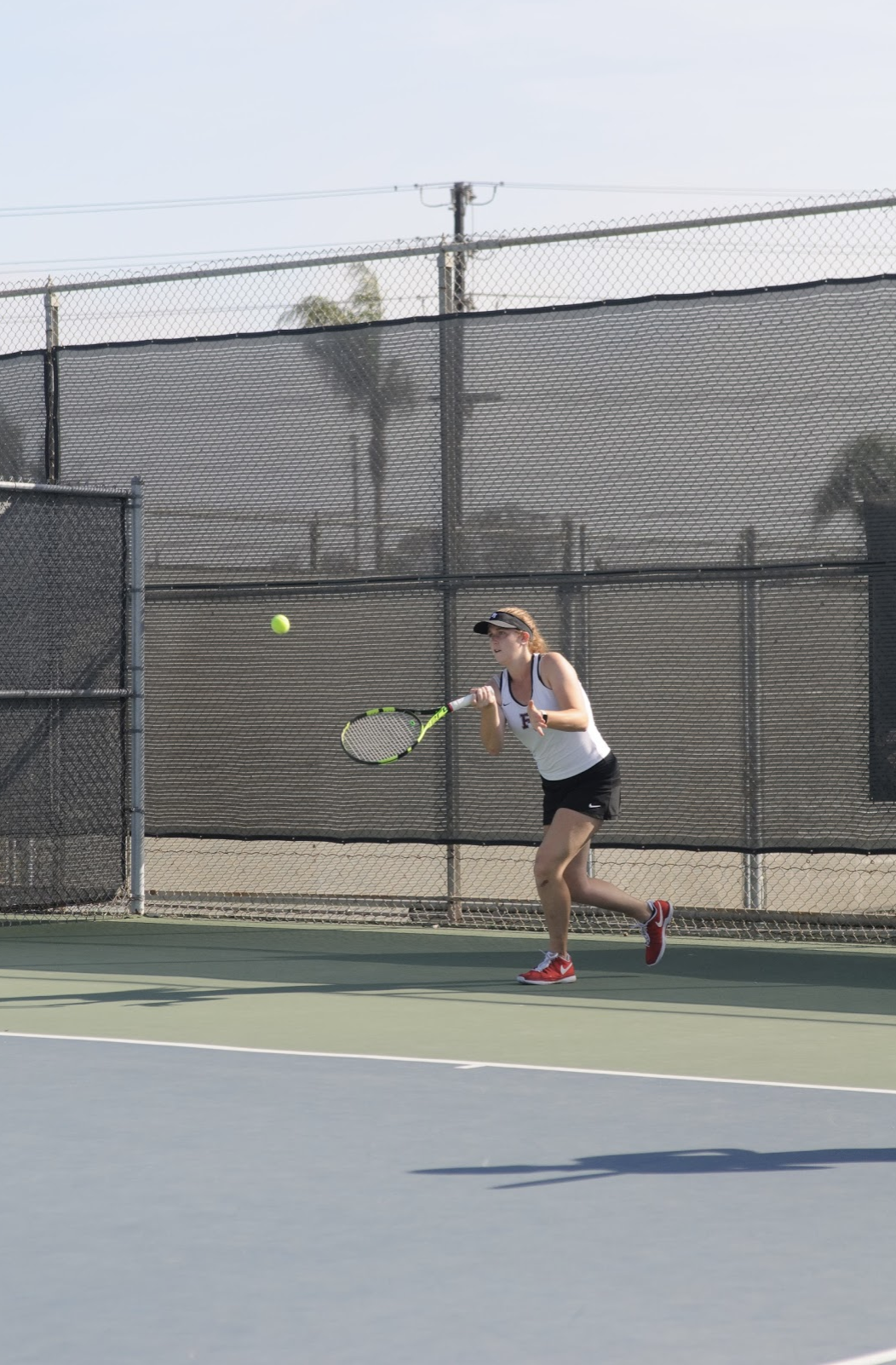 Alyssa MCLain ‘20 hits a ball across the net. Credit: Muriel Rowley / The Foothill Dragon Press