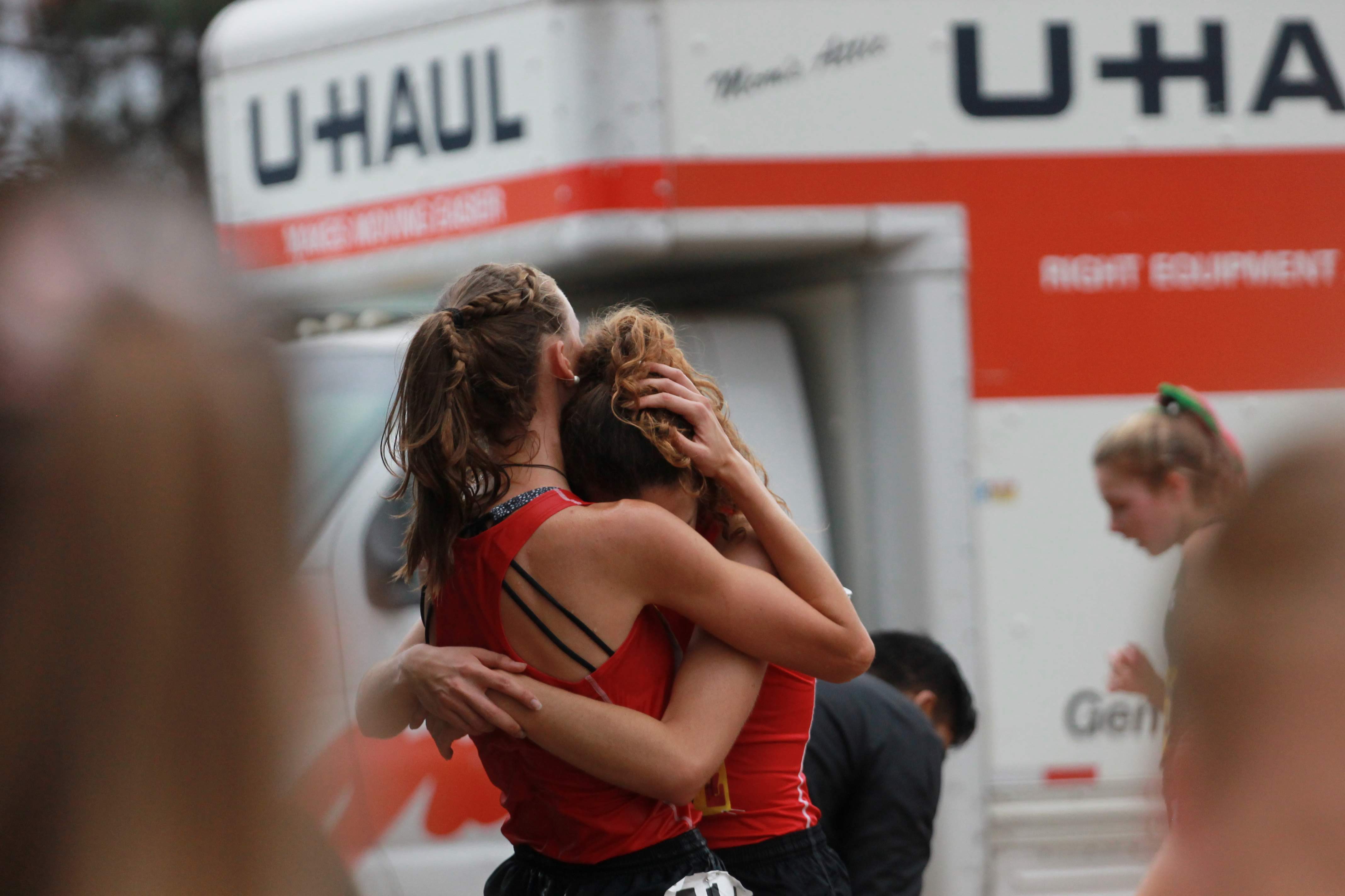 Lauren Kearney and Brooke Secreto hug after crossing the finish line. Credit: Jocelyn Brossia / The Foothill Dragon Press