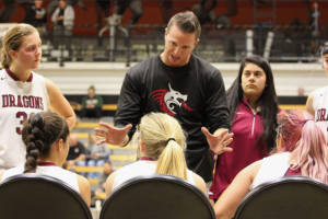 Coach Jason Edgmond speaks to athletes about game strategies. Credit: Ethan Crouch / The Foothill Dragon Press