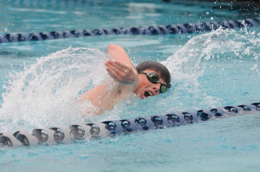 Brandon Rodgers ‘22 swims with speed down his lane.