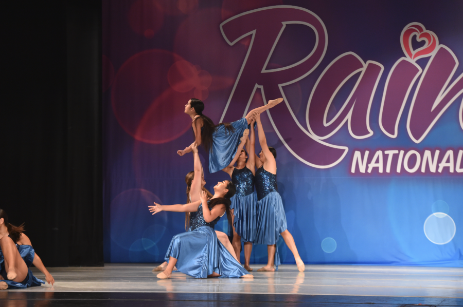 Vanessa Luna '19 soars high above the dance floor at a competition. 