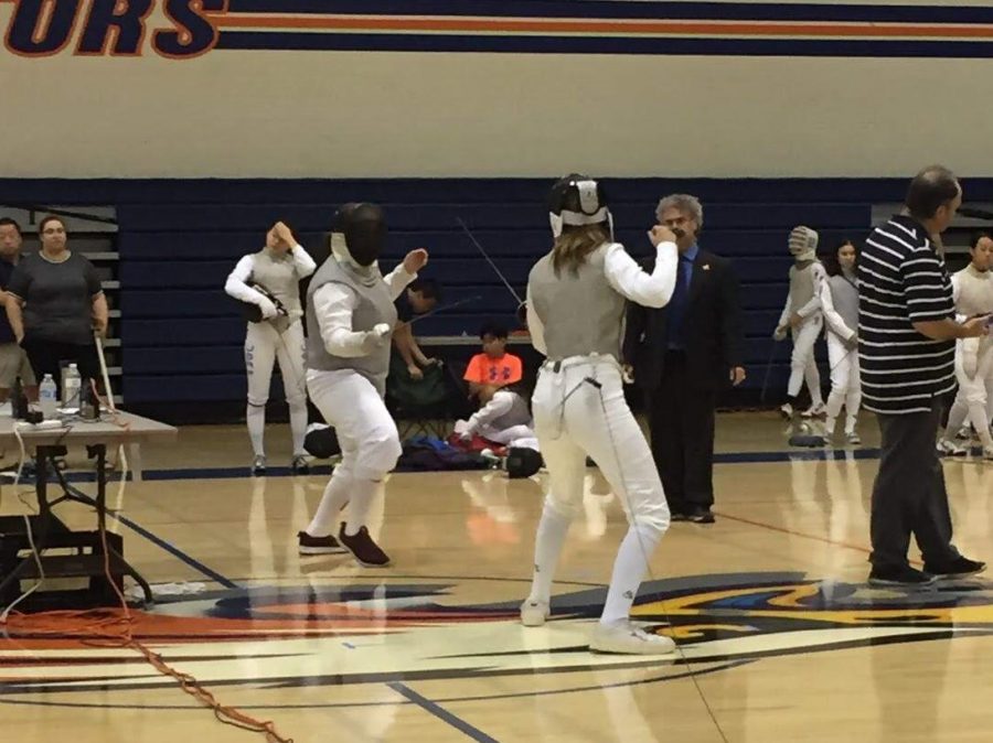 Juliet Ward 21 faces an opponent in a fencing due