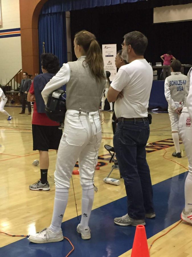 Juliet Ward 21 stands on the sidelines waiting for her turn at a fencing competition.
