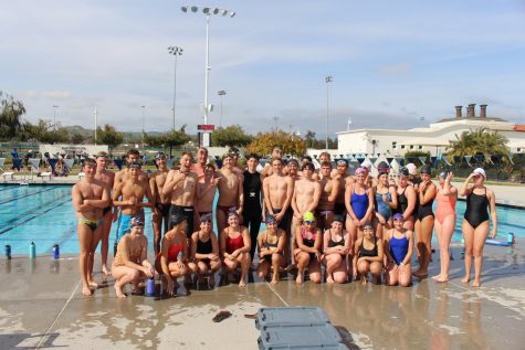 Sam Bova smiles alongside the swim team following their practice together.