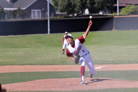 The ball launches from Charlie Montanos 19 hand on the pitching mound. 