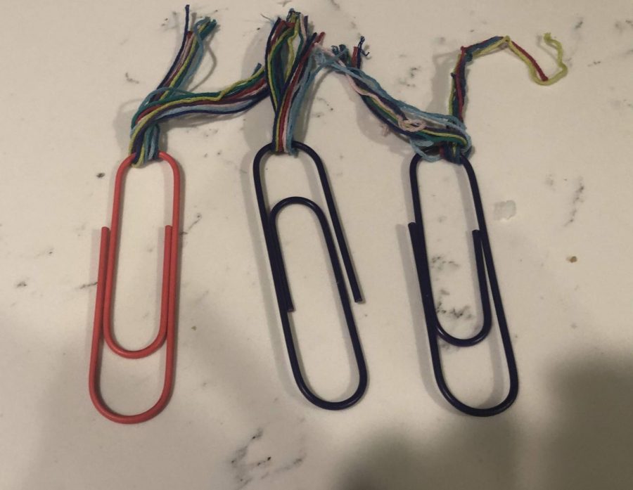 Tie Strings around paper clips.
