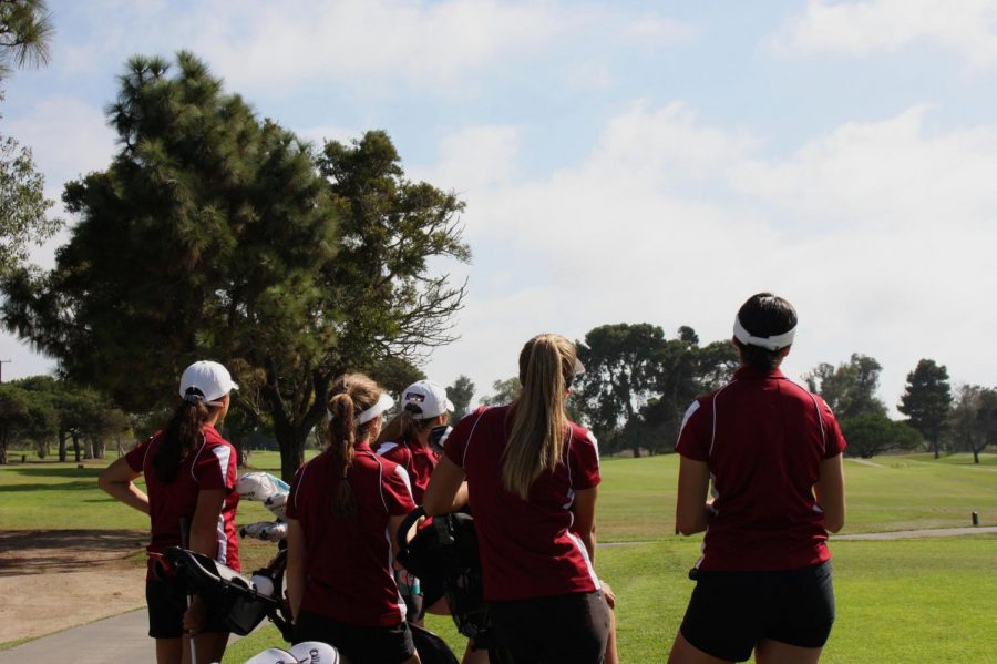 The girls golf team watches the sky set on one of their final matches together