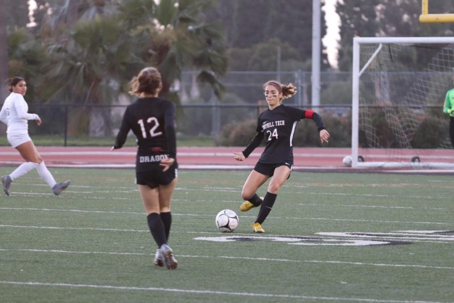 Kami Kunes 20 preparing to kick the ball up the field.