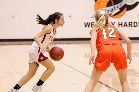 Cierra Marienthal 22 runs the ball up the court.