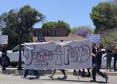 A large banner was carried in remembrance of the late George Floyd.
