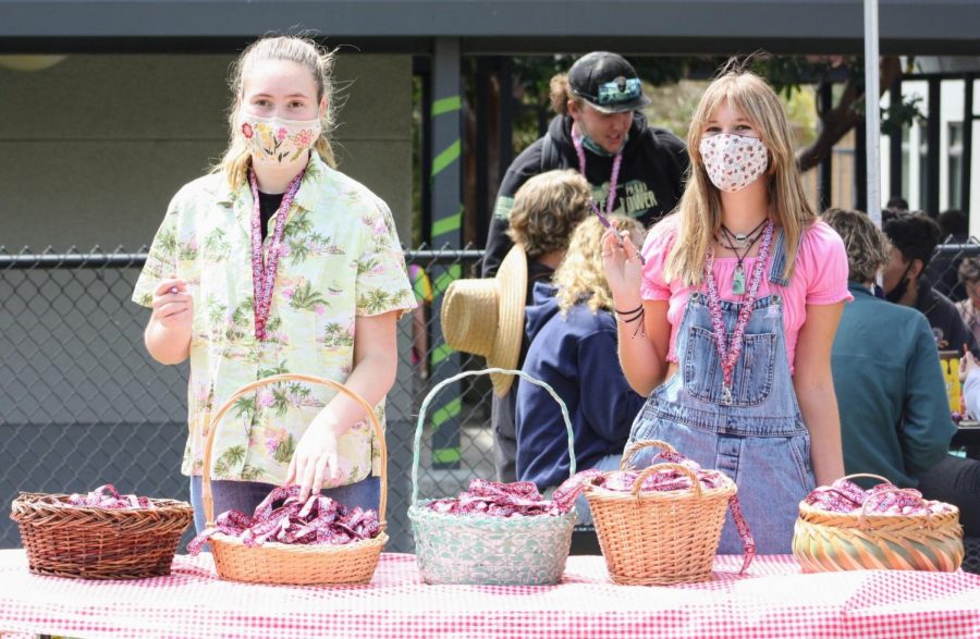 Elizabeth Ferris '21 and Clare Duganne '22 hand out lanyards at the Renaissance Rally.