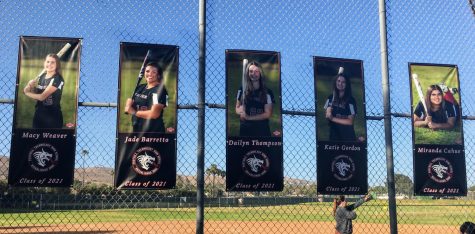 Softball team hangs banners for seniors Macy Weaver ‘21, Jade Barretto ‘21, Dailyn Thompson ‘21, Katie Gordon ‘21 and Miranda Cahue ‘21 on Senior Night.