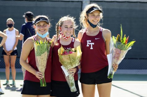 Jolie Seemayer 21, Cameron Wilcox 21 and Noelle Hayward 21 smile for their families after their senior banquet.