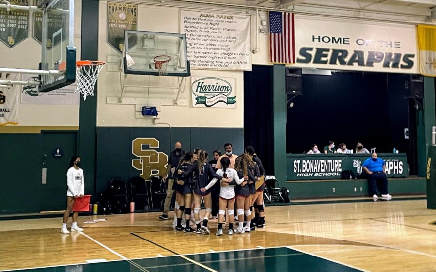 The varsity girls volleyball team huddles during a time out in an attempt to redeem themselves in the game.
