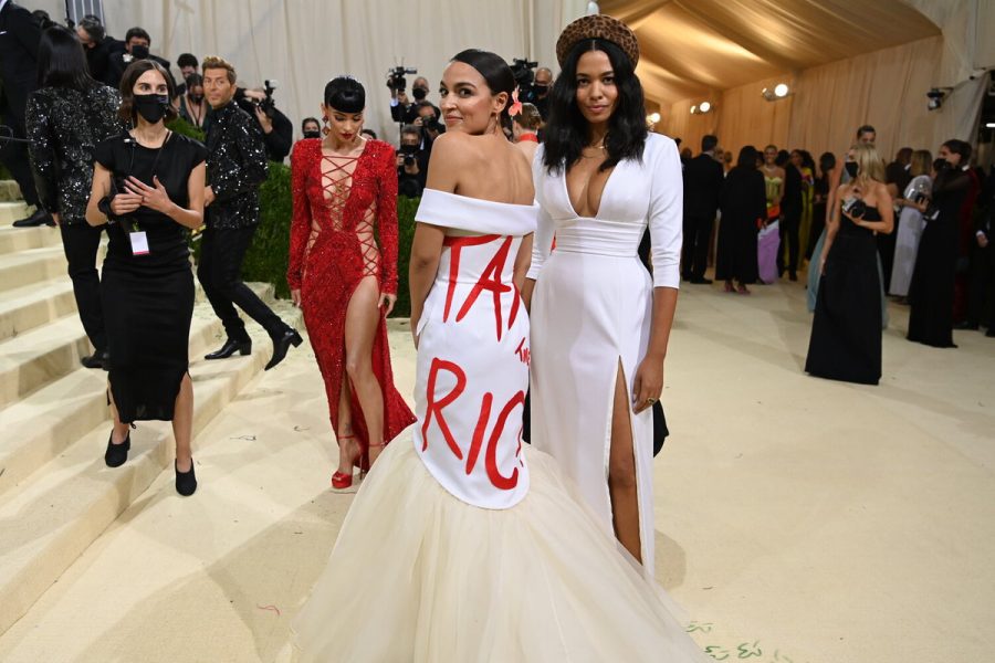 Representative Alexandria “AOC” Ocasio-Cortez walks down red carpet in news-provoking dress with red statement “Tax The Rich”. Source: Getty Image